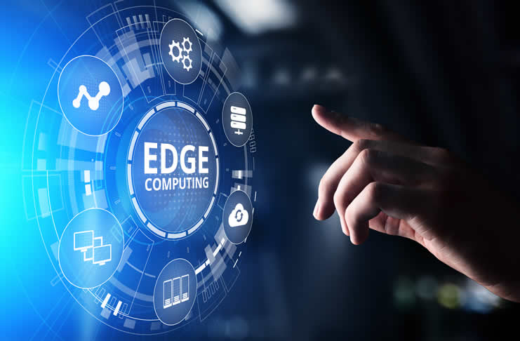 A hand reaching towards a glowing digital display labeled "Edge Computing," surrounded by various technology-related icons.